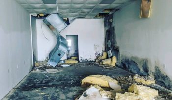 Mold-covered ductwork and drywall before remediation in commercial unit