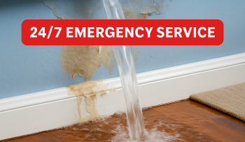 Burst frozen pipe spraying water inside a home causing flooding, with EMERG+NC Restoration 24/7 emergency service banner.