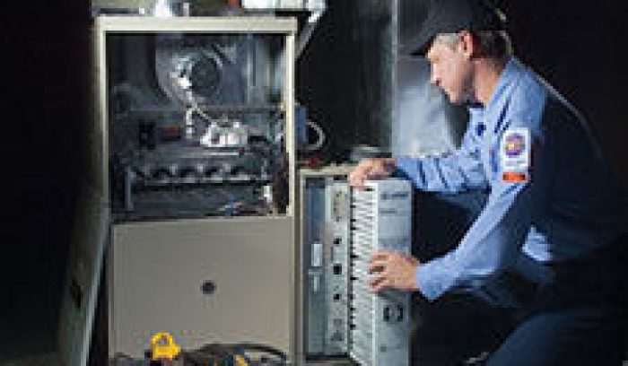 man working on furnace